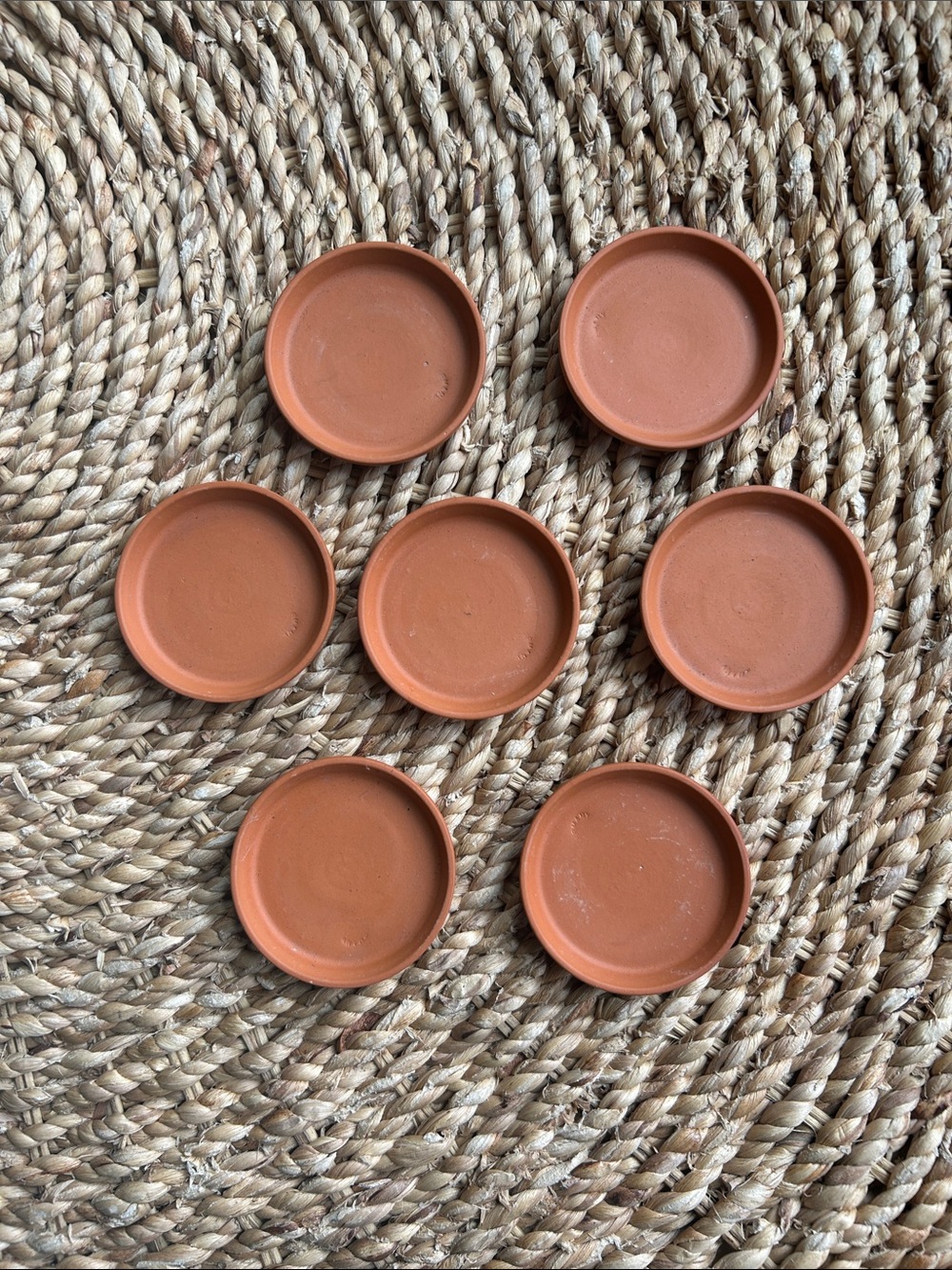 7 Terra Cotta saucers.